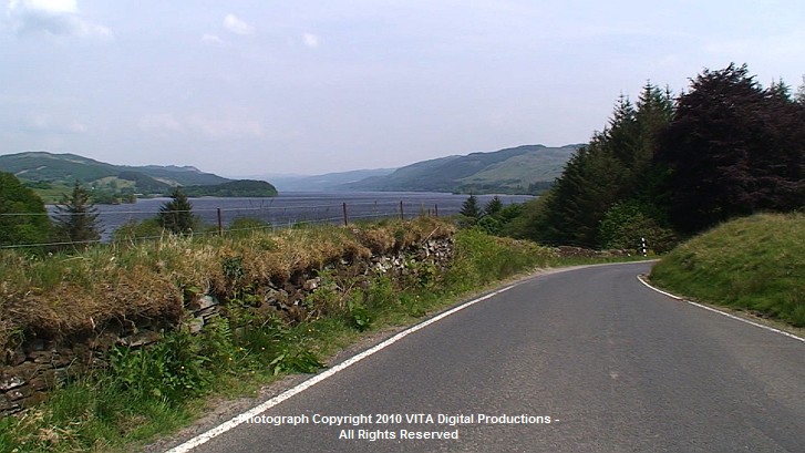 First a low stone wall adjoins the road then later, a beautiful lake.